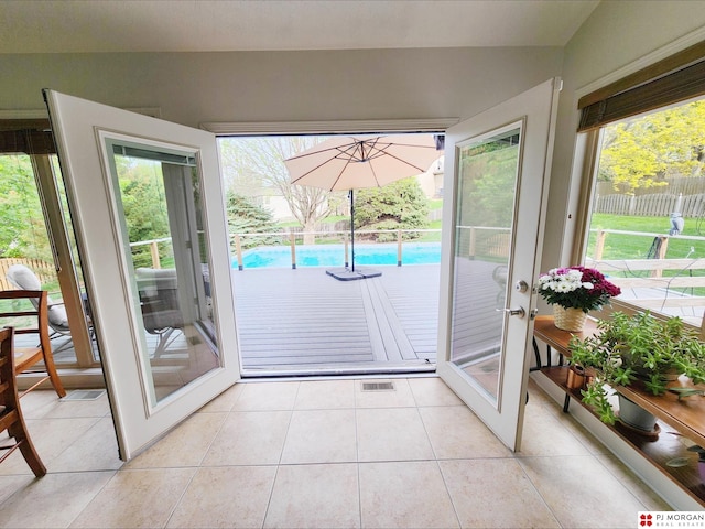 entryway featuring light tile patterned floors and french doors