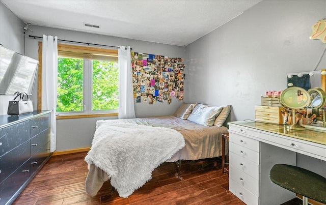 bedroom with dark wood-style floors