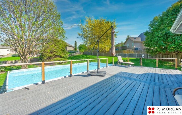 view of swimming pool featuring a deck