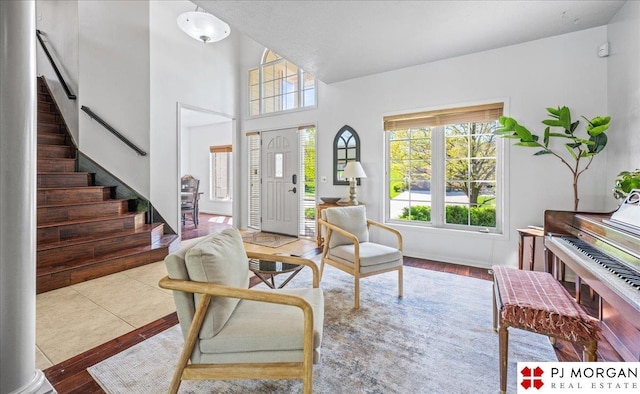 foyer entrance featuring stairway, plenty of natural light, and wood finished floors