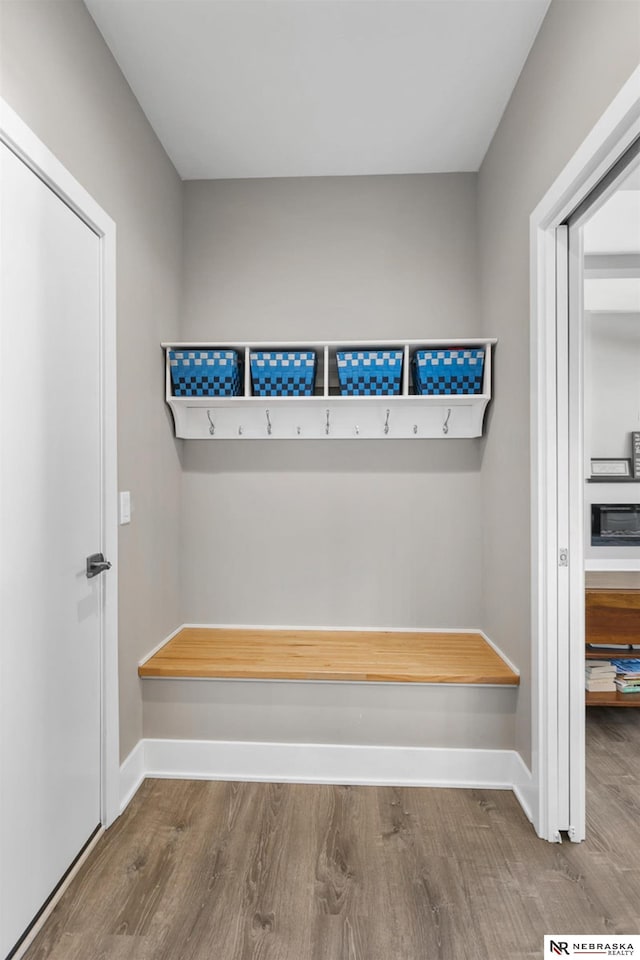 mudroom with wood finished floors and baseboards