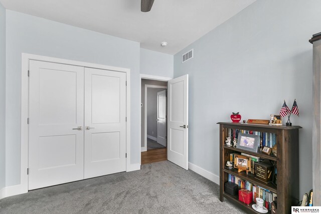 carpeted bedroom featuring baseboards, a closet, and a ceiling fan