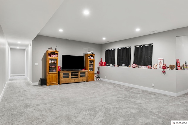 living room featuring light colored carpet, recessed lighting, and baseboards