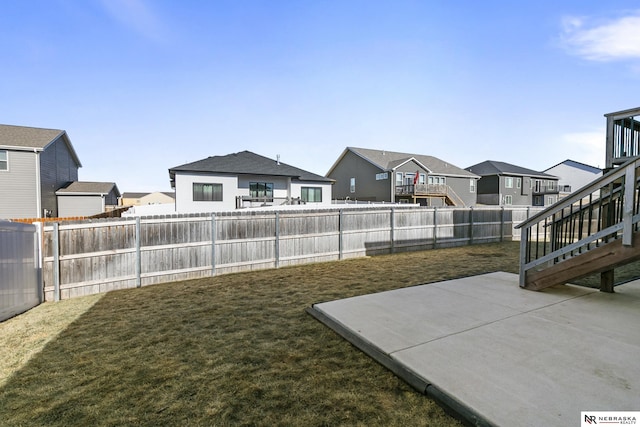 view of yard with a residential view and a patio