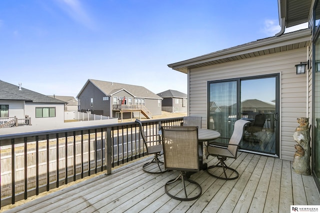 deck featuring a residential view and outdoor dining area