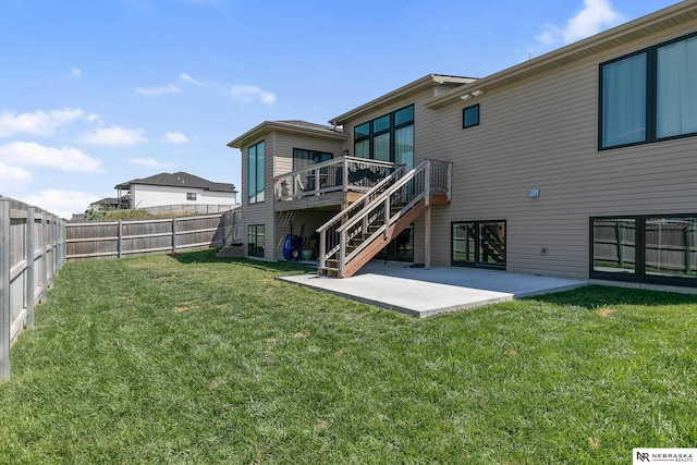 rear view of property with stairway, a patio area, and a deck