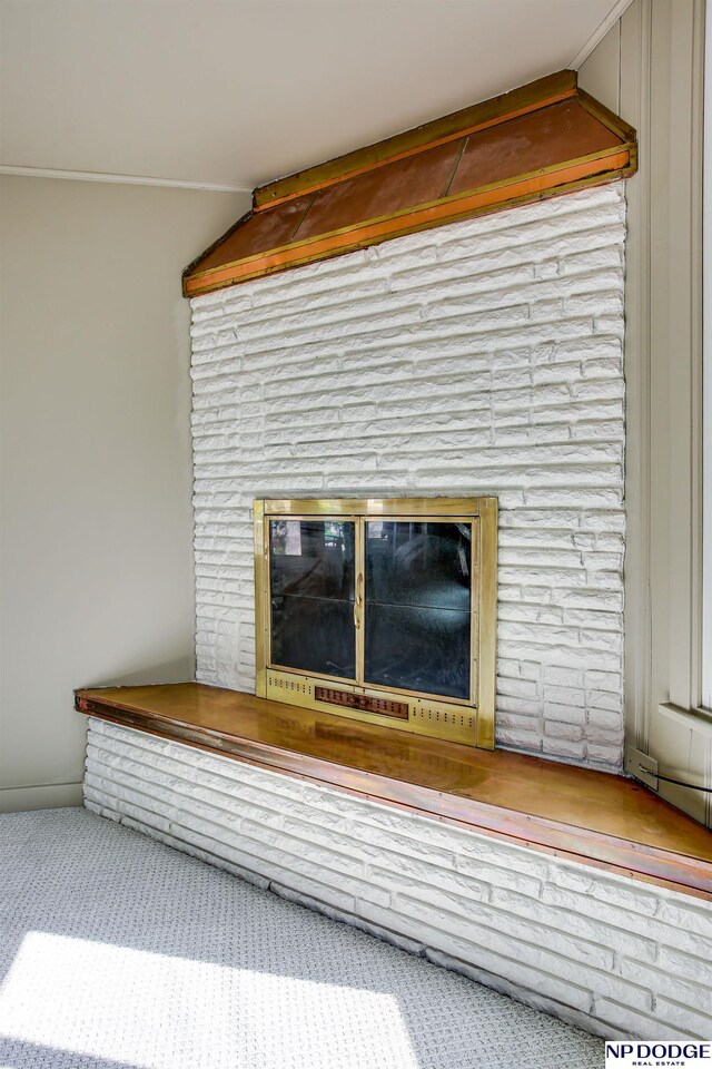 5650 Poppleton Ave, Omaha, NE 68106 - detailed view of a glass covered fireplace and carpet floors