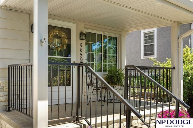 5650 Poppleton Ave, Omaha, NE 68106 - view of exterior entry with a porch and stucco siding