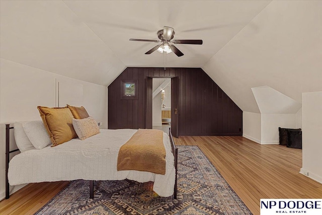 5650 Poppleton Ave, Omaha, NE 68106 - bedroom with wood finished floors, vaulted ceiling, wood walls, baseboards, and a ceiling fan