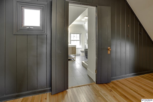 5650 Poppleton Ave, Omaha, NE 68106 - corridor with light wood-style flooring and wood walls