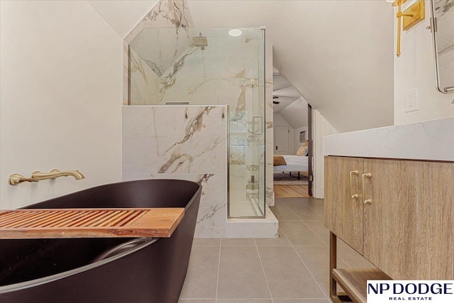 5650 Poppleton Ave, Omaha, NE 68106 - full bath featuring a stall shower, tile patterned flooring, lofted ceiling, and a soaking tub