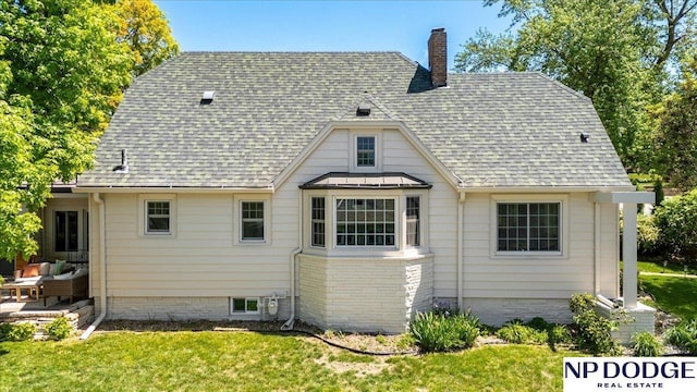 5650 Poppleton Ave, Omaha, NE 68106 - back of house with a chimney, roof with shingles, and a yard