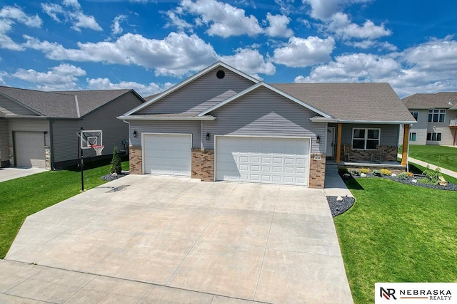 view of front of home with a garage, a front lawn, concrete driveway, covered porch, and brick siding
