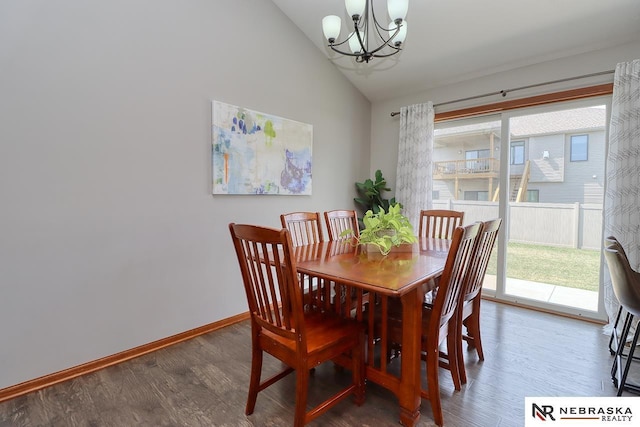 dining space featuring a chandelier, wood finished floors, baseboards, and high vaulted ceiling