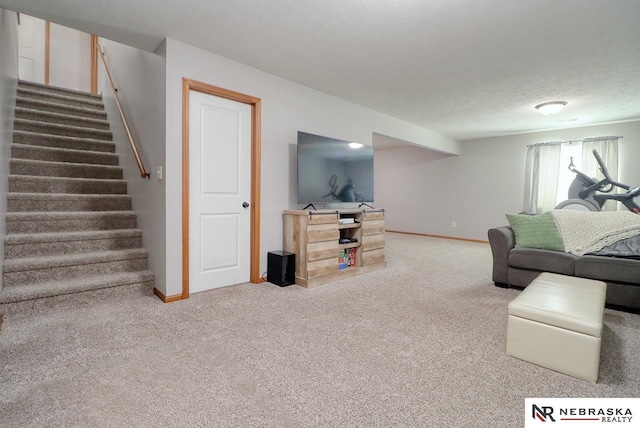 living area with carpet floors, baseboards, and stairway