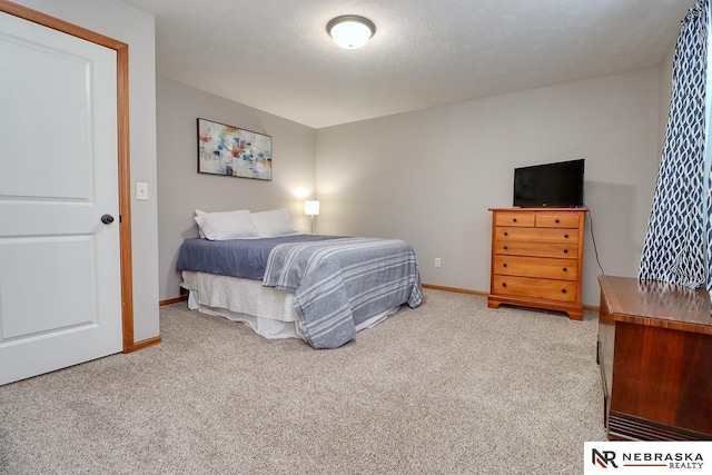 bedroom featuring carpet floors and baseboards
