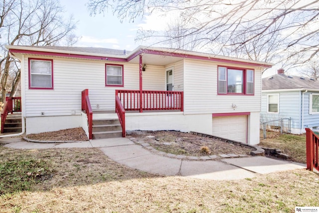 view of front of property featuring a garage and fence
