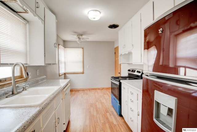 kitchen featuring refrigerator, range with electric cooktop, a sink, a ceiling fan, and healthy amount of natural light