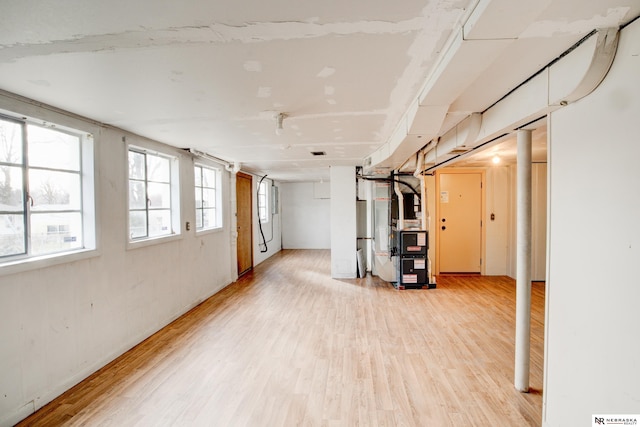 below grade area with light wood-style flooring