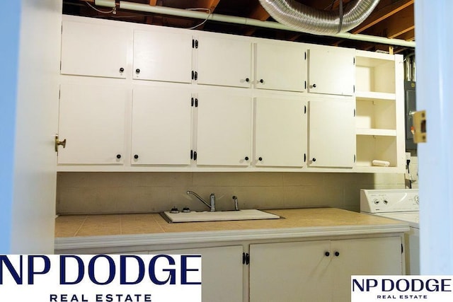 laundry room featuring cabinet space and washer / clothes dryer