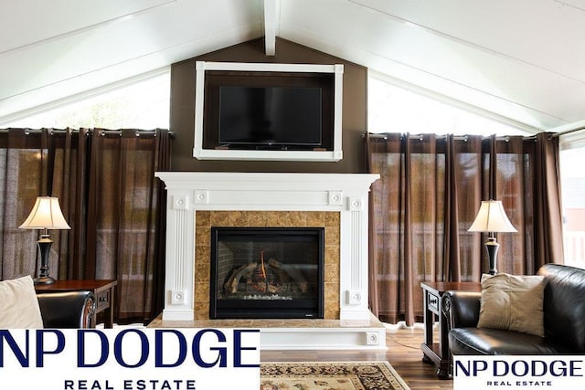 living area with wood finished floors and a tile fireplace