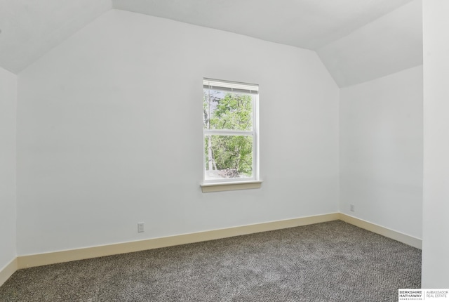 additional living space featuring vaulted ceiling, carpet flooring, and baseboards