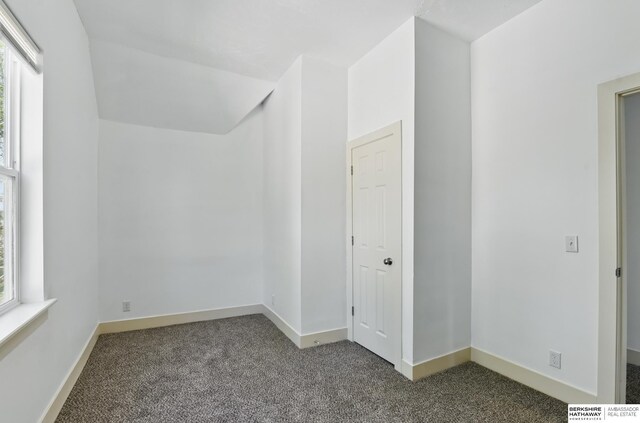 carpeted empty room with baseboards