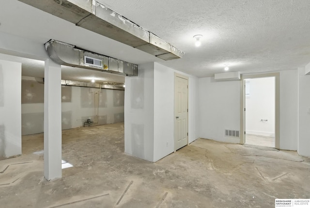 finished basement with a textured ceiling