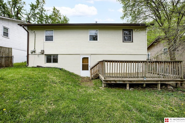 back of house featuring a yard and a deck