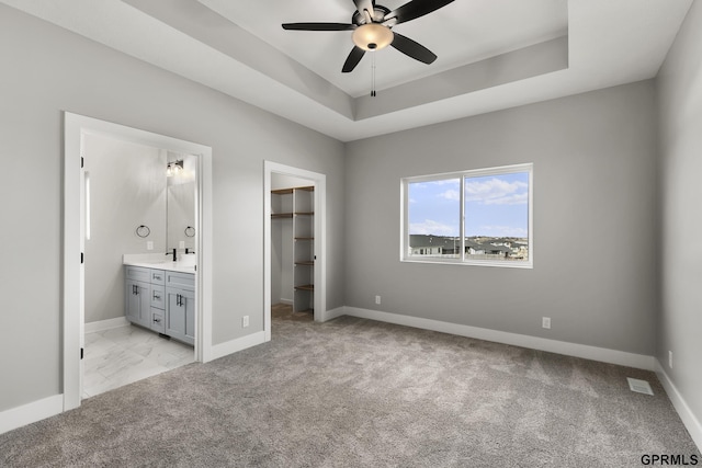 235 N 105th St, Lincoln, NE 68527 - unfurnished bedroom featuring a walk in closet, light carpet, and baseboards