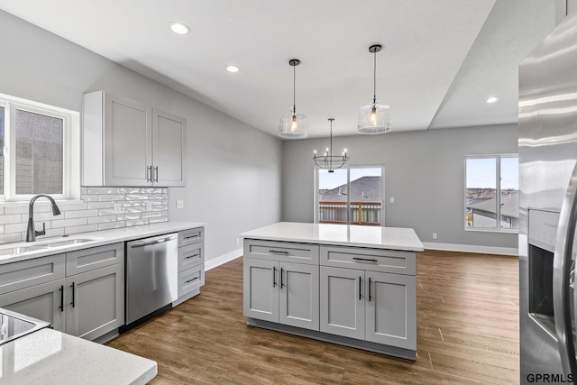 235 N 105th St, Lincoln, NE 68527 - kitchen featuring appliances with stainless steel finishes, gray cabinets, a sink, baseboards, and recessed lighting