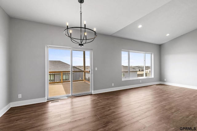 235 N 105th St, Lincoln, NE 68527 - empty room featuring healthy amount of natural light, a chandelier, dark wood-type flooring, baseboards, and recessed lighting