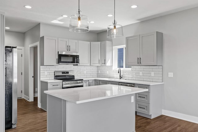235 N 105th St, Lincoln, NE 68527 - kitchen with stainless steel appliances, a sink, decorative backsplash, light countertops, and recessed lighting