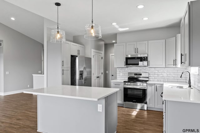 235 N 105th St, Lincoln, NE 68527 - kitchen featuring appliances with stainless steel finishes, a sink, dark wood-style floors, backsplash, and recessed lighting