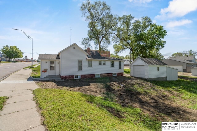 929 Main St, Seward, NE 68434 - view of side of home with a garage and a yard