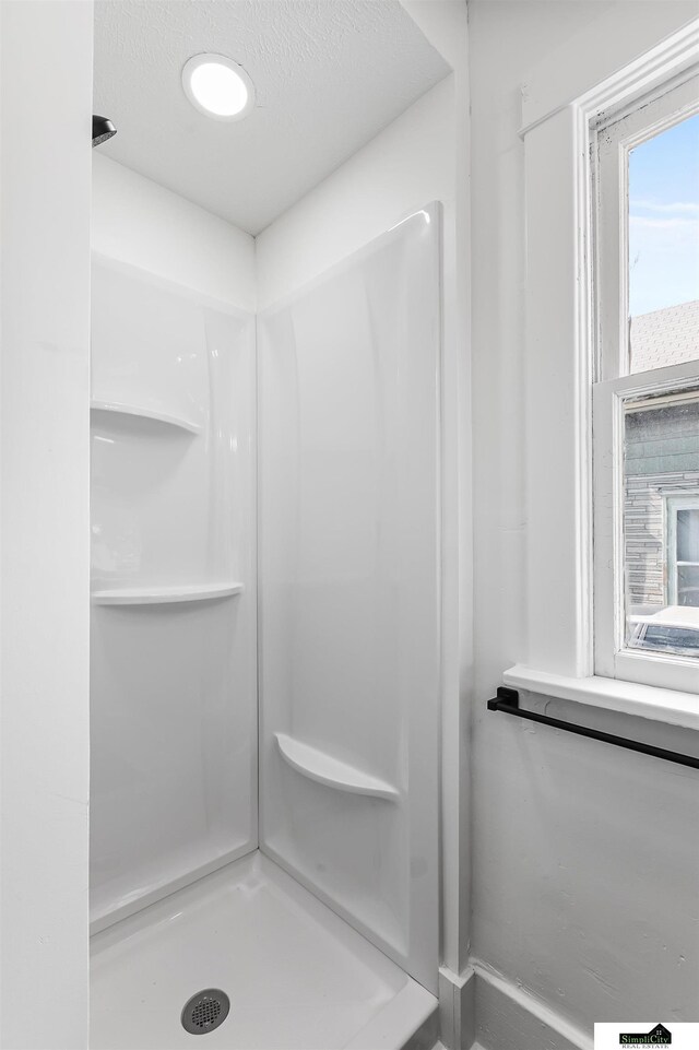 2139 S 8th St, Lincoln, NE 68502 - bathroom featuring a stall shower and a textured ceiling