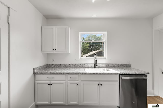 2139 S 8th St, Lincoln, NE 68502 - kitchen with dishwasher, a sink, white cabinetry, light stone countertops, and light wood-type flooring