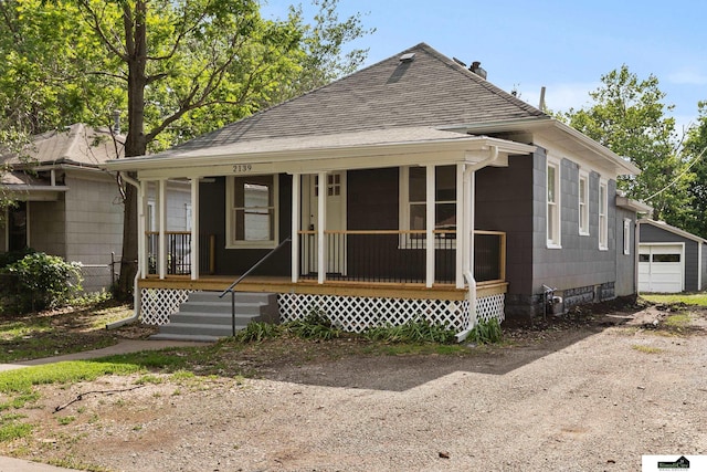 2139 S 8th St, Lincoln, NE 68502 - view of front of property featuring roof with shingles, covered porch, a detached garage, and driveway