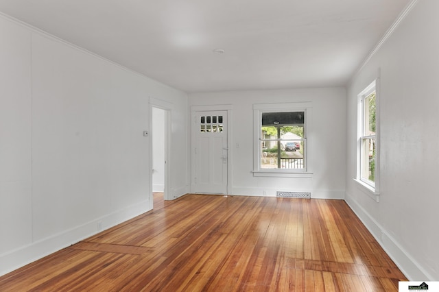 2139 S 8th St, Lincoln, NE 68502 - empty room featuring wood-type flooring, baseboards, and crown molding