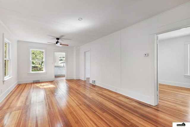2139 S 8th St, Lincoln, NE 68502 - spare room featuring a ceiling fan, light wood finished floors, and baseboards