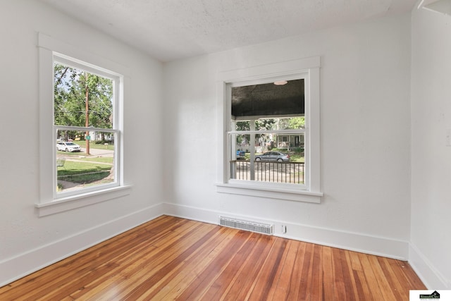 2139 S 8th St, Lincoln, NE 68502 - empty room with wood-type flooring, baseboards, and a textured ceiling