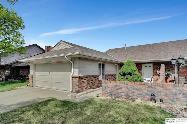 ranch-style home with brick siding, a garage, concrete driveway, a front yard, and a shingled roof