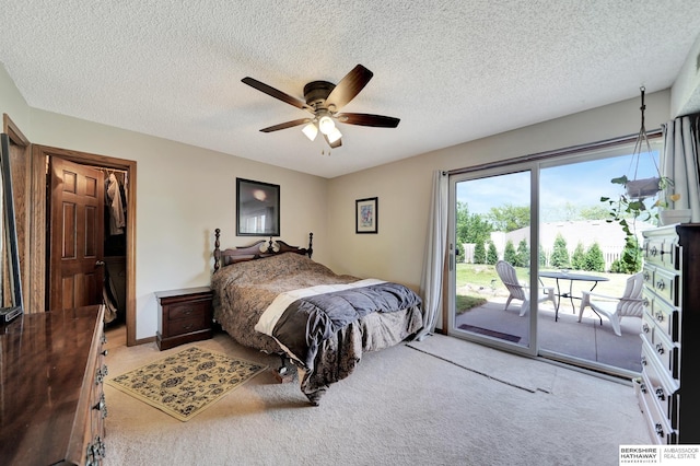 bedroom with access to exterior, carpet flooring, a textured ceiling, and a ceiling fan