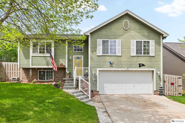 bi-level home with an attached garage and driveway