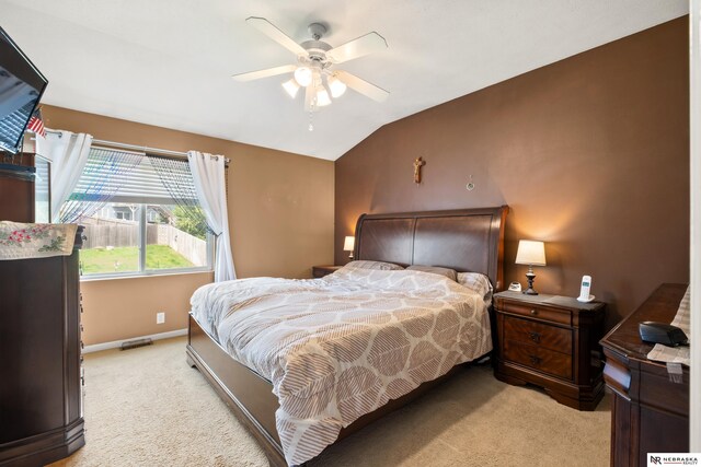 bedroom featuring carpet flooring, vaulted ceiling, baseboards, and ceiling fan