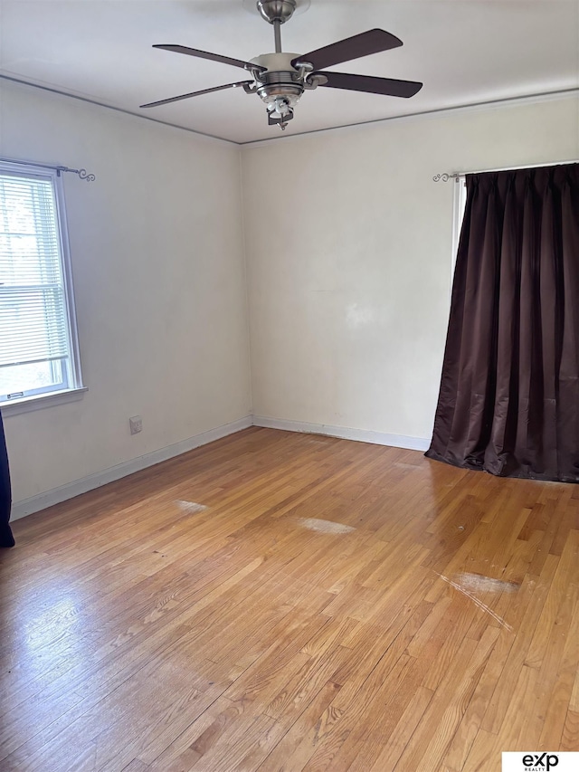 unfurnished room featuring a ceiling fan and light wood-style flooring