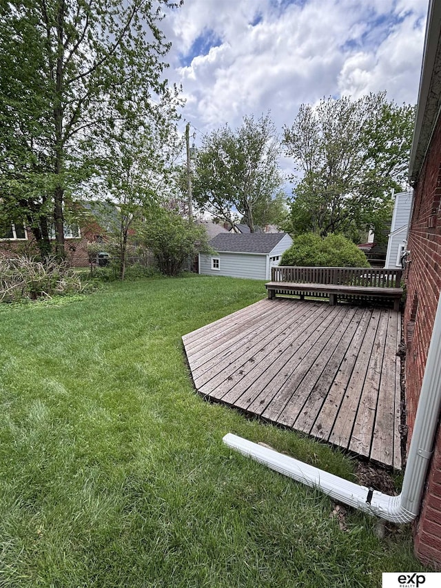 view of grassy yard with a wooden deck