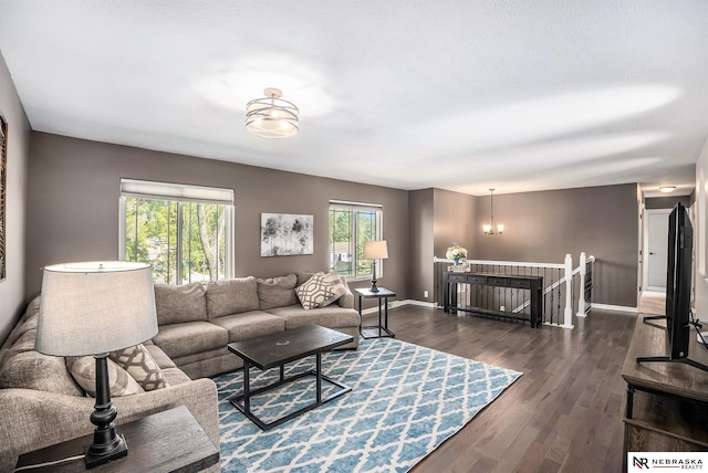 living room featuring plenty of natural light, dark wood finished floors, and baseboards