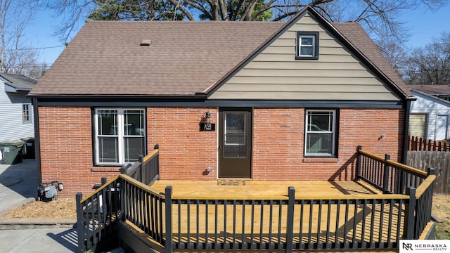 3772 F St, Lincoln, NE 68510 - back of house with brick siding, roof with shingles, and a wooden deck