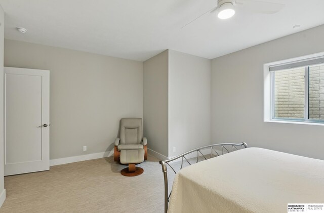 carpeted bedroom featuring baseboards and ceiling fan